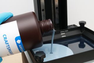 Resin pouring into a Creality Halot-One Plus 3D printer