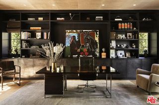 A home office with black lacquered shelves