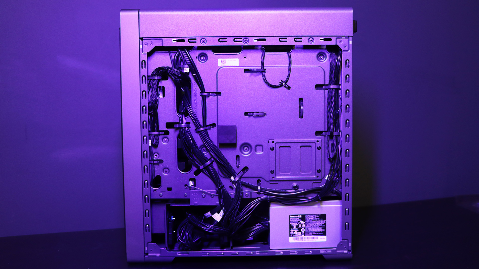 Lenovo Legion Tower 5i PC on a table with a purple light on it