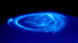 The Hubble Space Telescope's close-up view of an electric-blue aurora on the giant planet Jupiter, eerily glowing one half billion miles away.