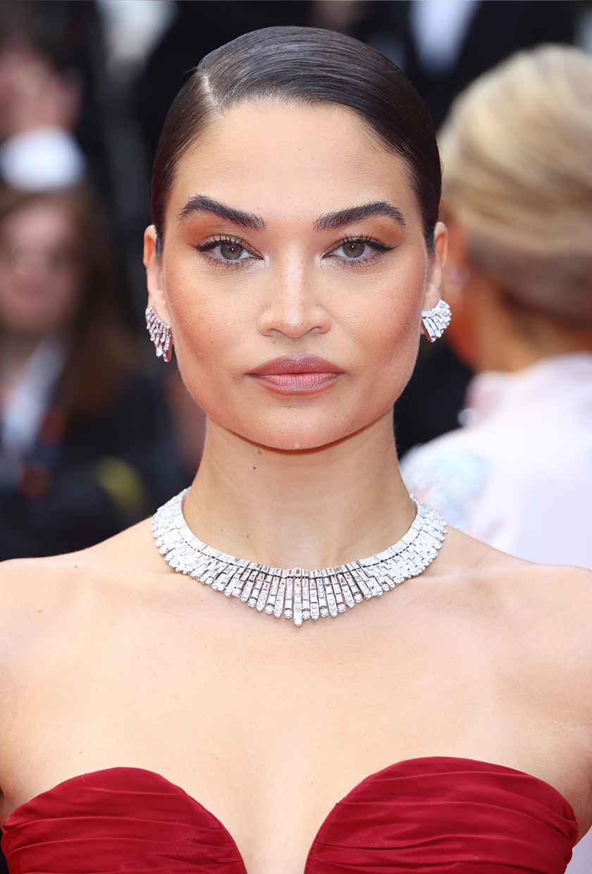 Shanina Shaik with side parted sleek bun hairstyle at Cannes 2024