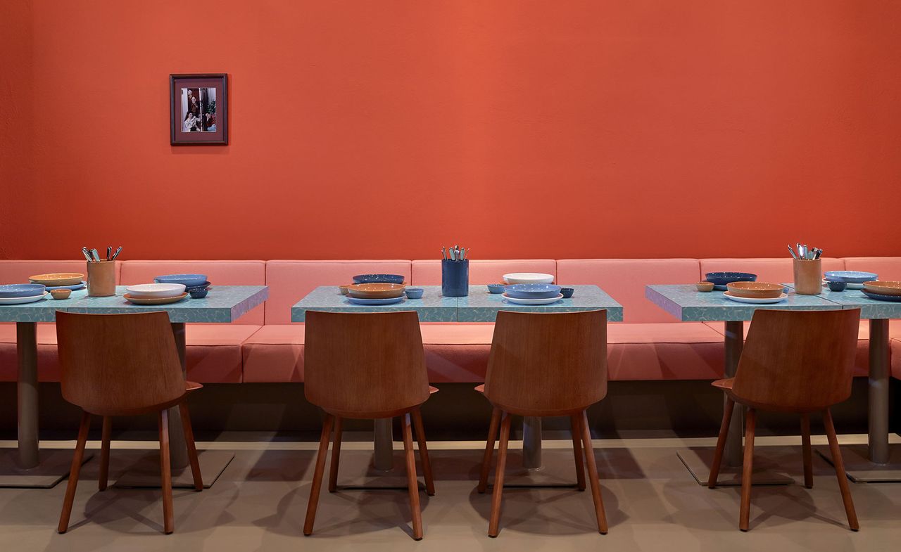 Restaurant interior with red walls &amp; red seating