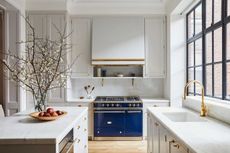white kitchen with brass fixtures