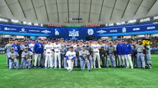 Players from the Los Angeles Dodgers and Hanshin Tigers gather after their game at the Tokyo Dome on March 16, 2025.