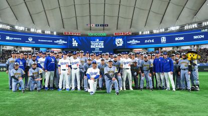 Players from the Los Angeles Dodgers and Hanshin Tigers gather after their game at the Tokyo Dome on March 16, 2025.