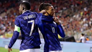 Michael Olise, wearing the blue of France, shushes the crowd after scoring in the Nations League 2026/27.