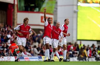 Thierry Henry celebrates with his Arsenal team-mates after scoring against Manchester United at Highbury in October 2000.