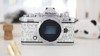 Nikon Z fc Heralbony edition, sat on a white dresser with a mirror and lifestyle accessories