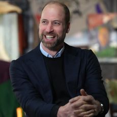 Prince William wearing a blue blazer and smiling 