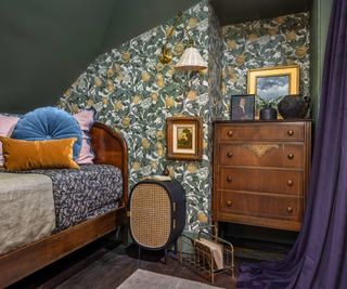 bedroom with green ceiling and orange blossom wallpaper and brown chest of drawers