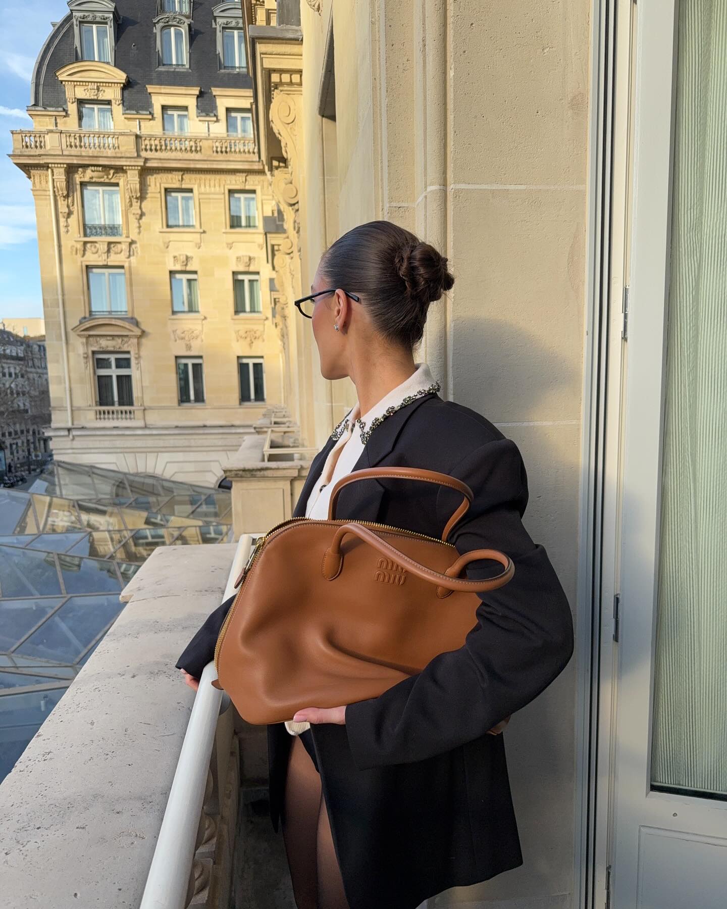 An image of @emmaleger with a ladylike handbag from Miu Miu.