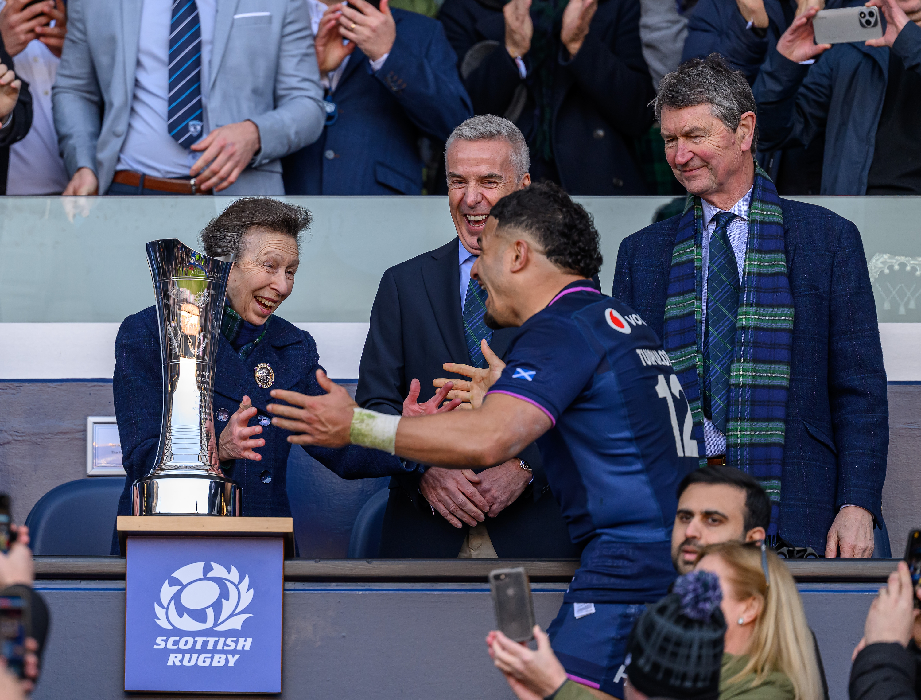 Princess Anne pretending to hug a rugby player