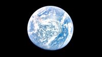 a blue-and-white planet on a black background