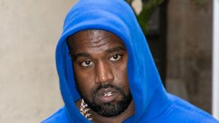 Kanye West in a blue hoodie