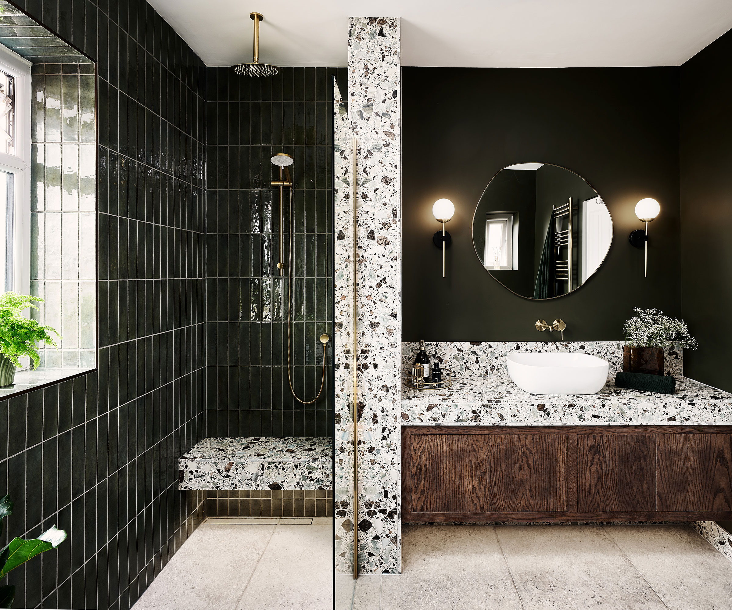 dark green bathroom with terrazzo effect tiles and walk in shower