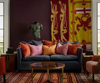 Blue sofa decorated with pillows upholstered in colorful antique textiles