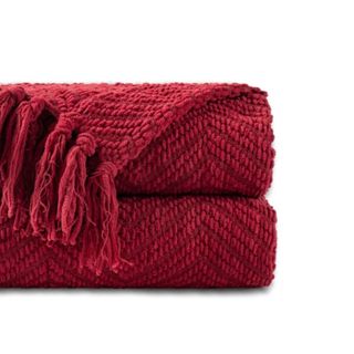 A dark red knitted throw blanket