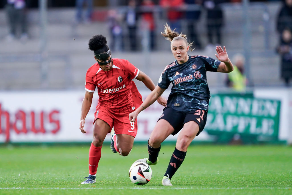 Shekiera Martinez of SC Freiburg (L) and Georgia Stanway of FC Bayern München (R) battle for the ball during the Women's DFB-Cup round of 16 match between Sport-Club Freiburg and FC Bayern München at Dreisamstadion on November 24, 2024 in Freiburg im Breisgau, Germany.