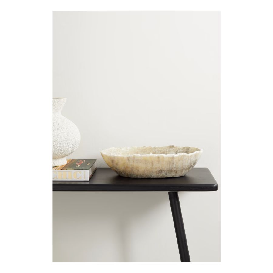 Onyx bowl on black wood surface