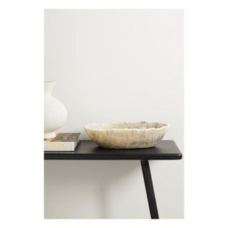 Onyx bowl on black wood surface