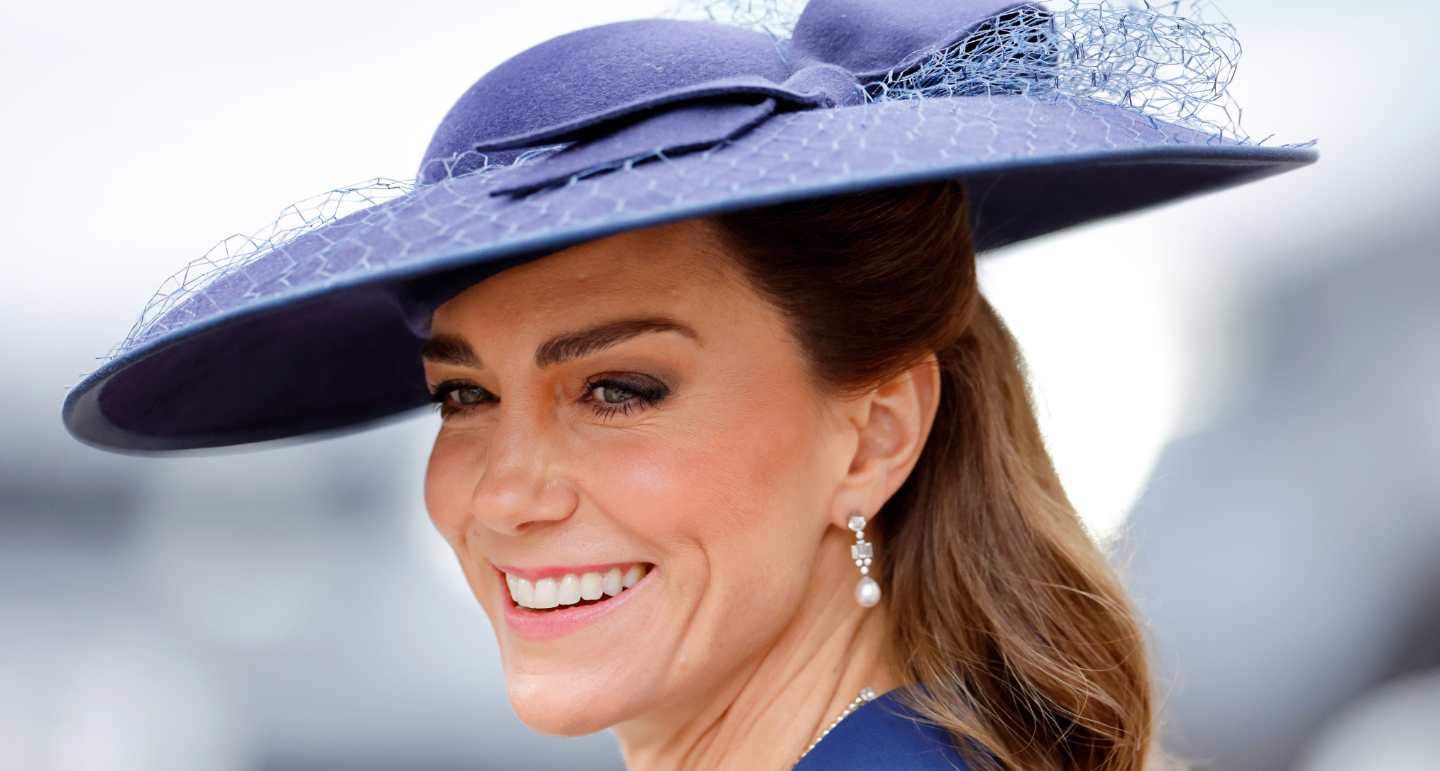Princess Kate wearing a blue hat and smiling