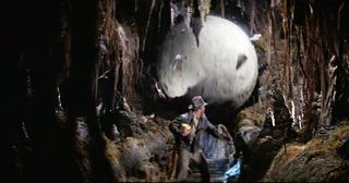 Harrison Ford as Indiana Jones running from the boulder in Raiders Of The Lost Ark