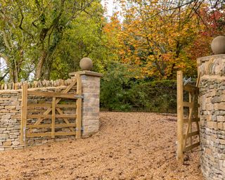 gravel driveway with wooden gates