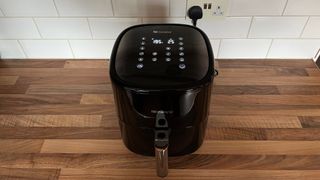 The Proscenic T22 Air Fryer switched on, on a kitchen countertop