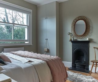 neutral bedroom with cast iron fireplace