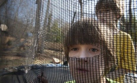 Twins Ben (front) and Sam Schwenker, who were diagnosed with autism at 18 months, play on their trampoline: A new study may help scientists come closer to understanding the disease&amp;#039;s origins.