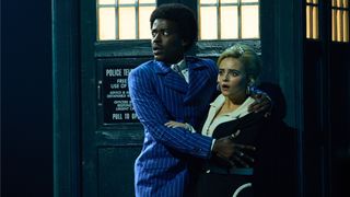 The Doctor (Ncuti Gatwa) and Ruby Sunday (Millie Gibson) looking terrified in their 60s-inspired outfits in front of the TARDIS in Doctor Who season 14 episode 2