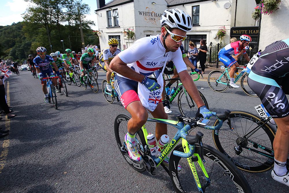 British champion Adam Blythe takes on some food during stage 5 at the Tour of Britain.