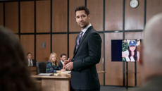 Mickey stands in a court room full of people in The Lincoln Lawyer season 3