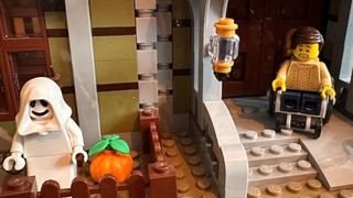 LEGO Haunted House closeup with ghost and wheelchair-bound visitor