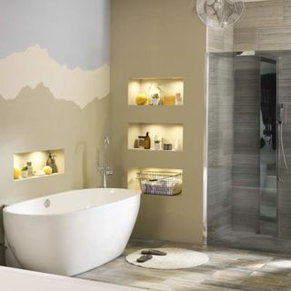 neutral bathroom with recessed shelving around bathtub