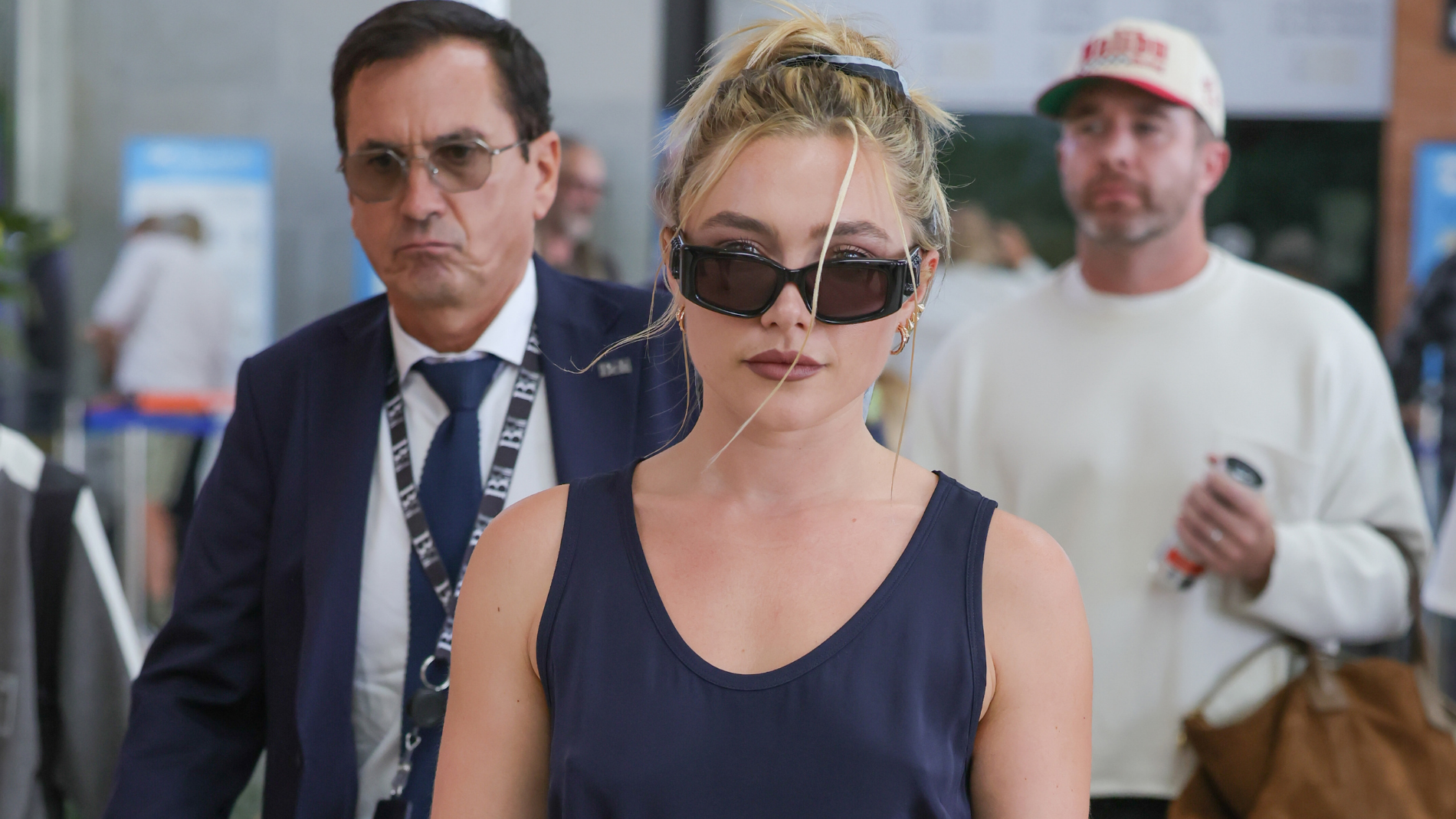 Florence Pugh arrives at the Venice airport in a blue dress and high-heeled sandals. 