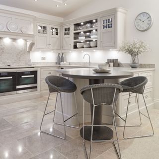 Grey kitchen in G shape with breakfast bar stools