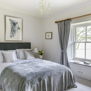bedroom with master bed and gray curtains