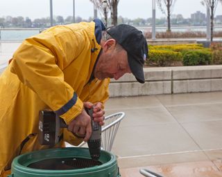 Man drills hole into rain barrel