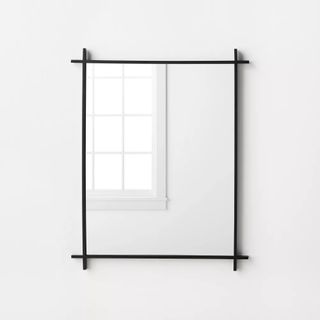 Studio McGee Cross Corner Mirror in black sitting on white wall