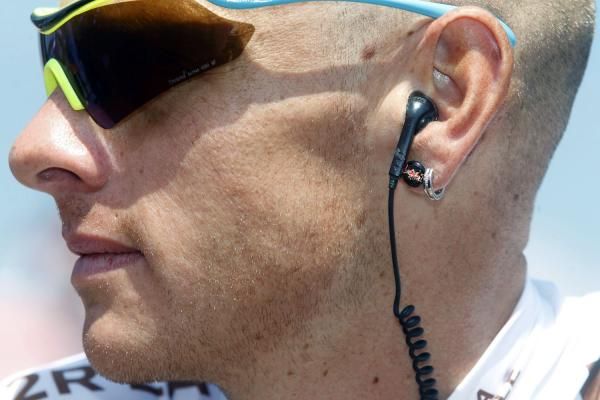 John Gadret wears a race radio
