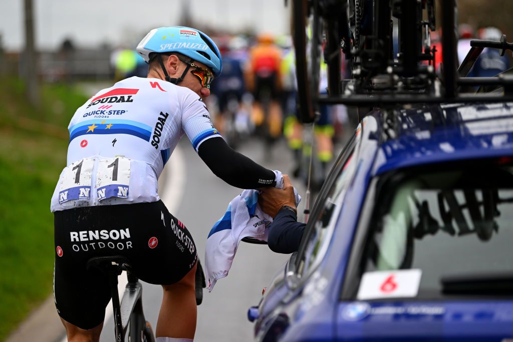 DE PANNE BELGIUM MARCH 22 Fabio Jakobsen of The Netherlands and Team Soudal Quick Step assisted by his team car during the 47th Minerva Classic Brugge De Panne 2023 a 211km one day race from Brugge to De Panne on March 22 2023 in De Panne Belgium Photo by Luc ClaessenGetty Images