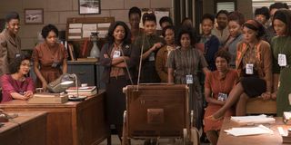 The female mathematicians watch as American astronauts go to space in Hidden Figures