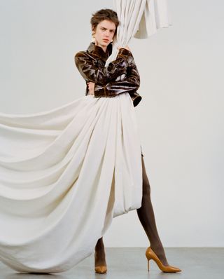 Pre Fall 2024 Best Looks Fashion Shoot featuring woman holding curtain in leather jacket and pointed stilettos