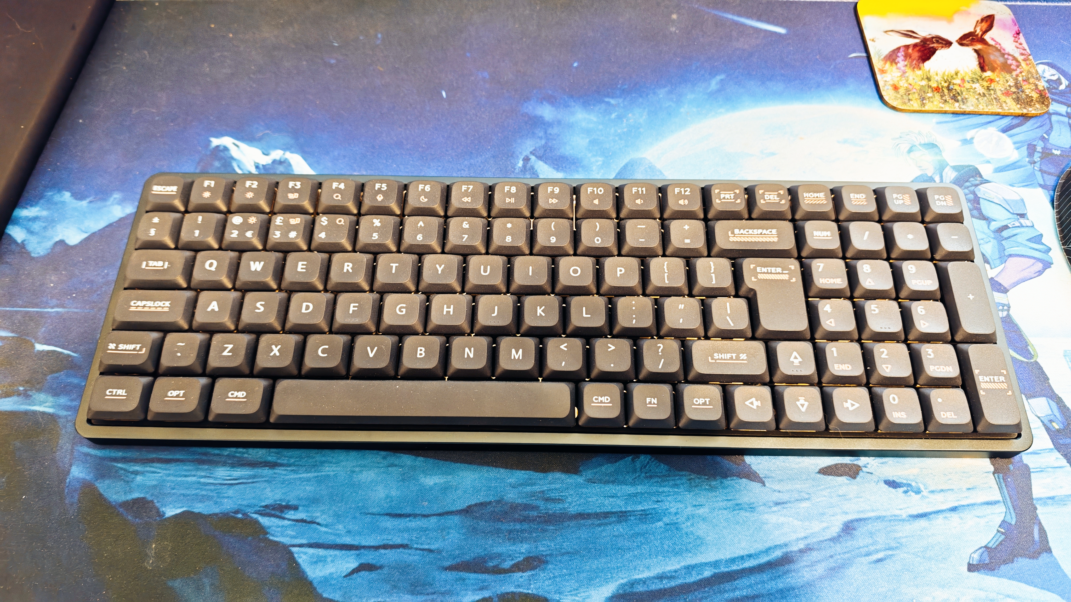 A black IQUNIX Magi96 keyboard on a desk mat
