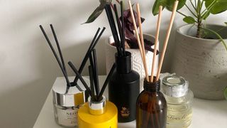 The best reed diffusers as reviewed by Annie in her bedroom on her chest of drawers with plant beside them