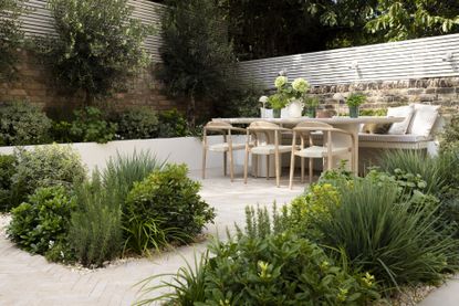 a mediterranean garden in london with modern minimalist furniture