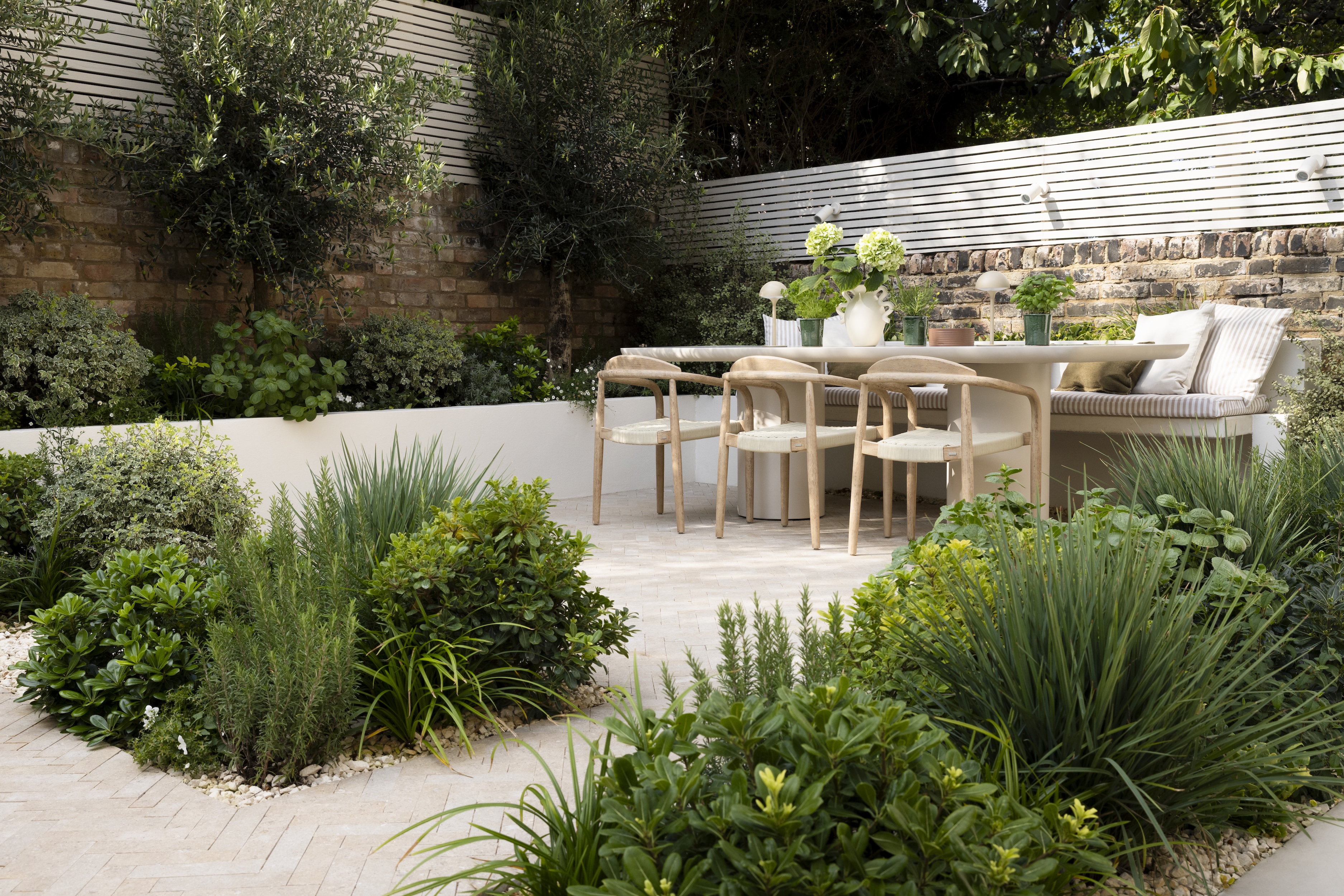 a mediterranean garden in london with modern minimalist furniture