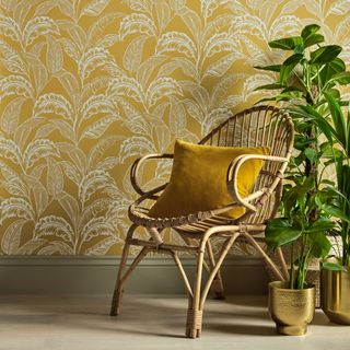 mozambique wallpaper with large-scale leaf print and cushion on chair