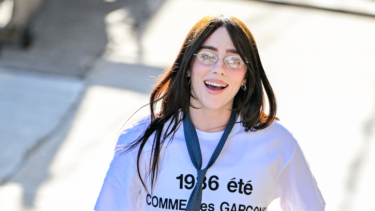 Billie Eilish wearing glassing tie and white graphic t-shirt